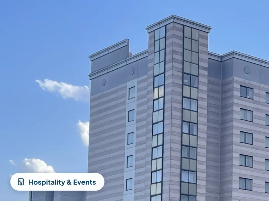 Hotel tower in Rosemont, IL against a blue sky, representing hospitality and event IT